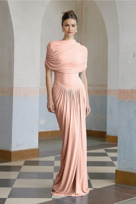 A woman wearing a long pink asymmetric maxi dress with pleated details and a flowing skirt