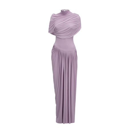 A woman wearing a long purple asymmetric maxi dress with pleated details standing against a plain background