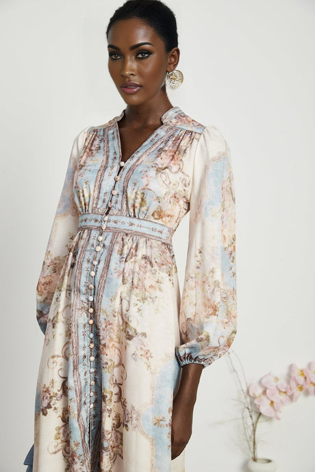A woman wearing a long sleeve floral print bohemian style dress with a flowing silhouette and vibrant colors