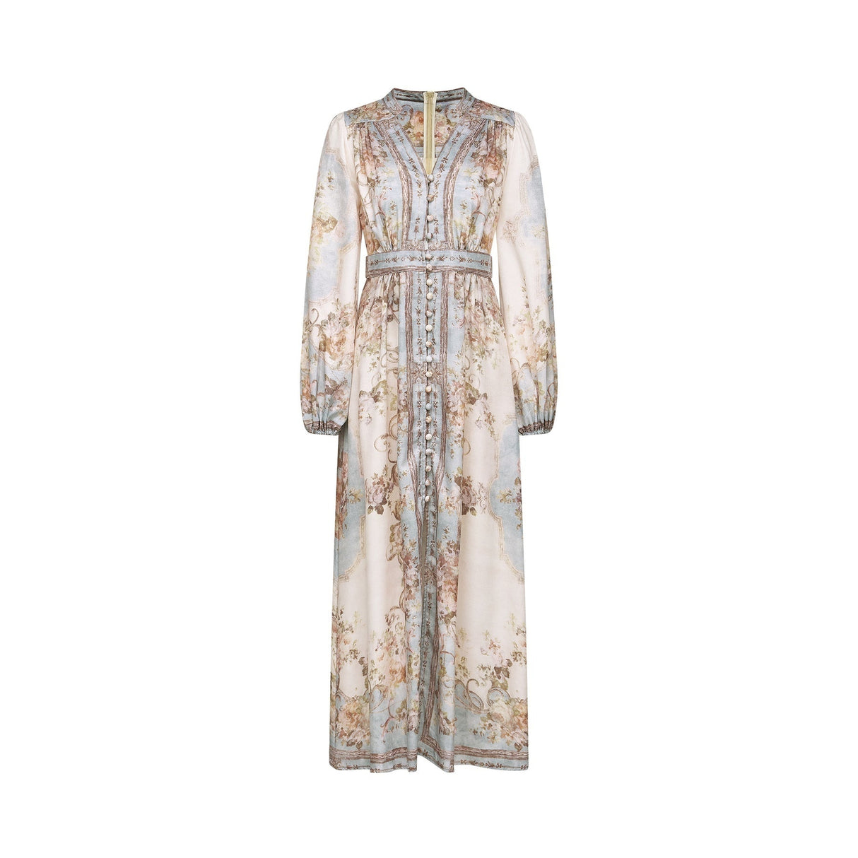A woman wearing a long sleeve floral print boho dress with a flowing skirt and feminine silhouette in a nature inspired setting
