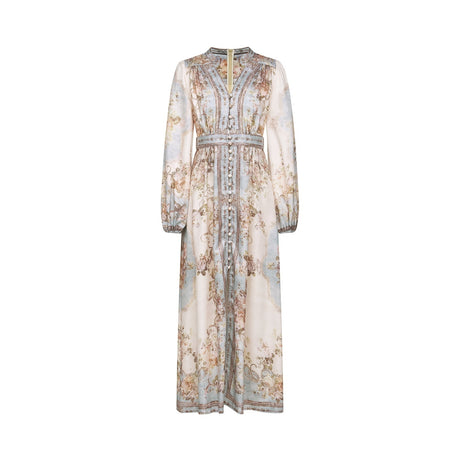 A woman wearing a long sleeve floral print boho dress with a flowing skirt and feminine silhouette in a nature inspired setting