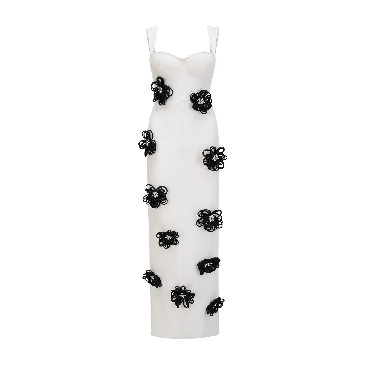 A woman wearing a long white bandage dress with floral applique detailing standing against a plain background