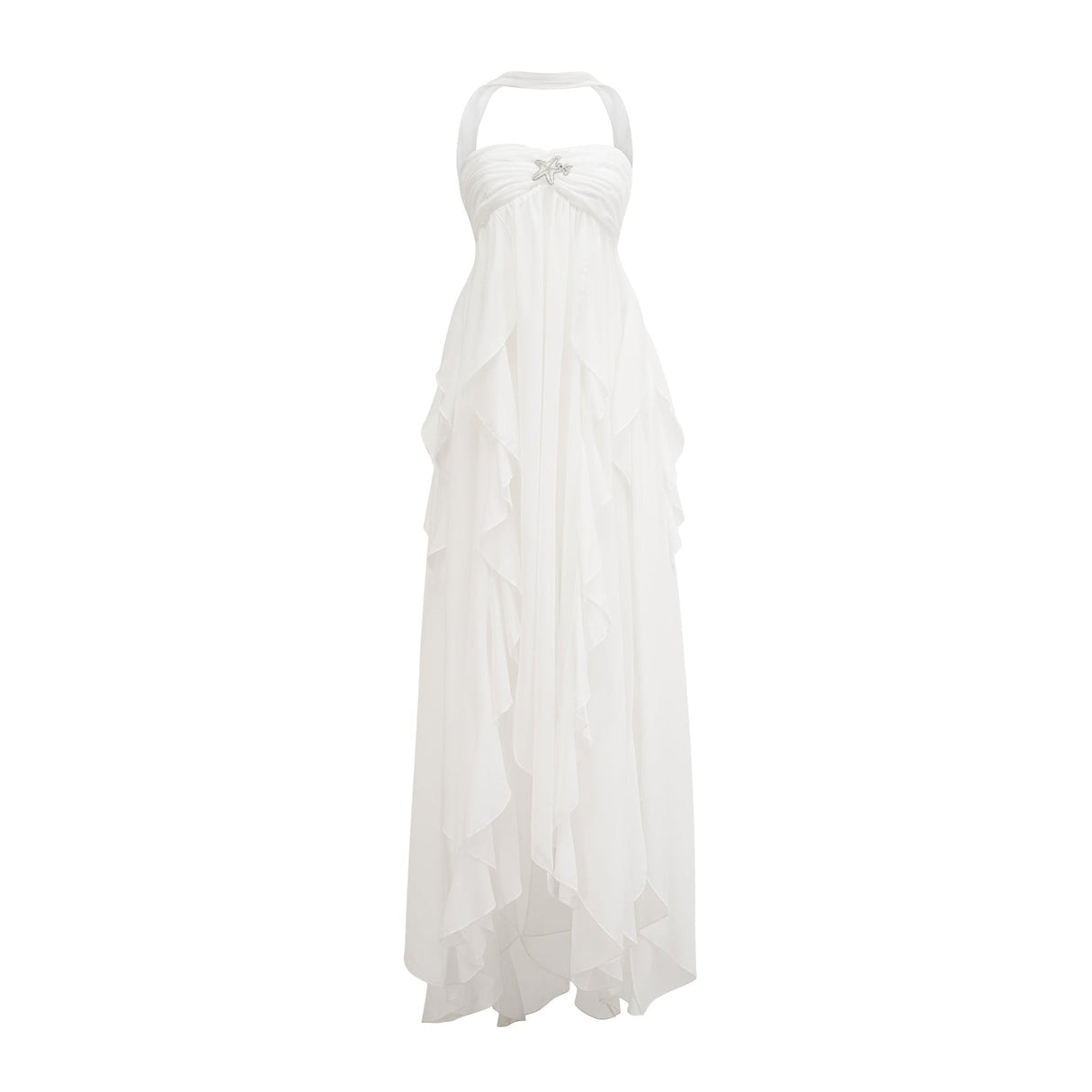A woman wearing a long white chiffon maxi dress with ruffles and a halter neckline