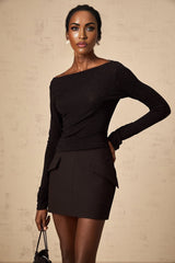 A woman wearing a matching black sequined top and skirt set The top is sleeveless with a high neckline and the skirt is knee length Both pieces feature allover sequin embellishment creating a sparkling effect