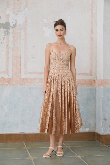A woman wearing a matching cream colored crochet lace cardigan and dress set The dress is sleeveless and knee length while the cardigan has long sleeves Both pieces feature intricate lace patterns