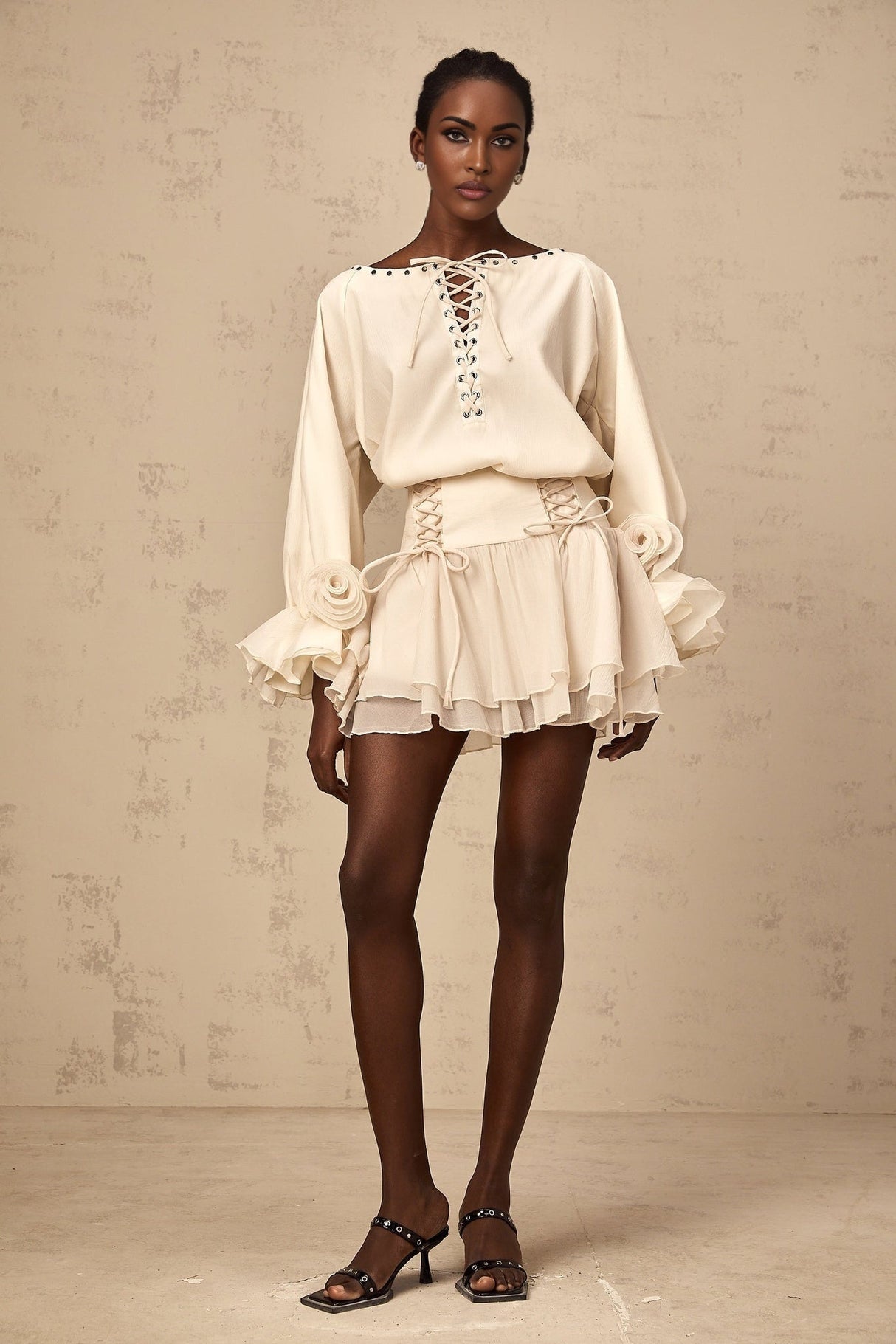 A woman wearing a matching set consisting of a white ruffled blouse with selftie detail and a coordinating skirt the outfit has a feminine and elegant appearance