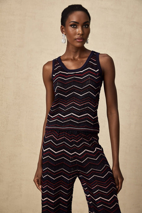 A woman wearing a matching set consisting of a zigzag patterned crochet knit top and trousers in a bohemian style named Emmanuelle