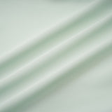 A woman wearing a midi length dress with ruffled details and embellishments The dress has a fitted silhouette and appears to be in a soft fabric
