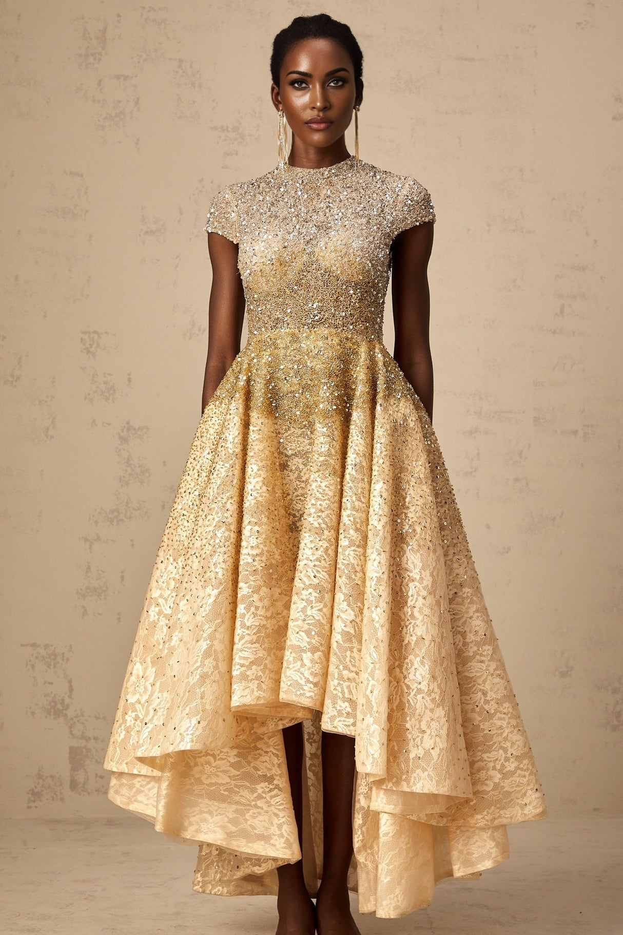 A woman wearing a neutral colored sequined dress with a high low hemline