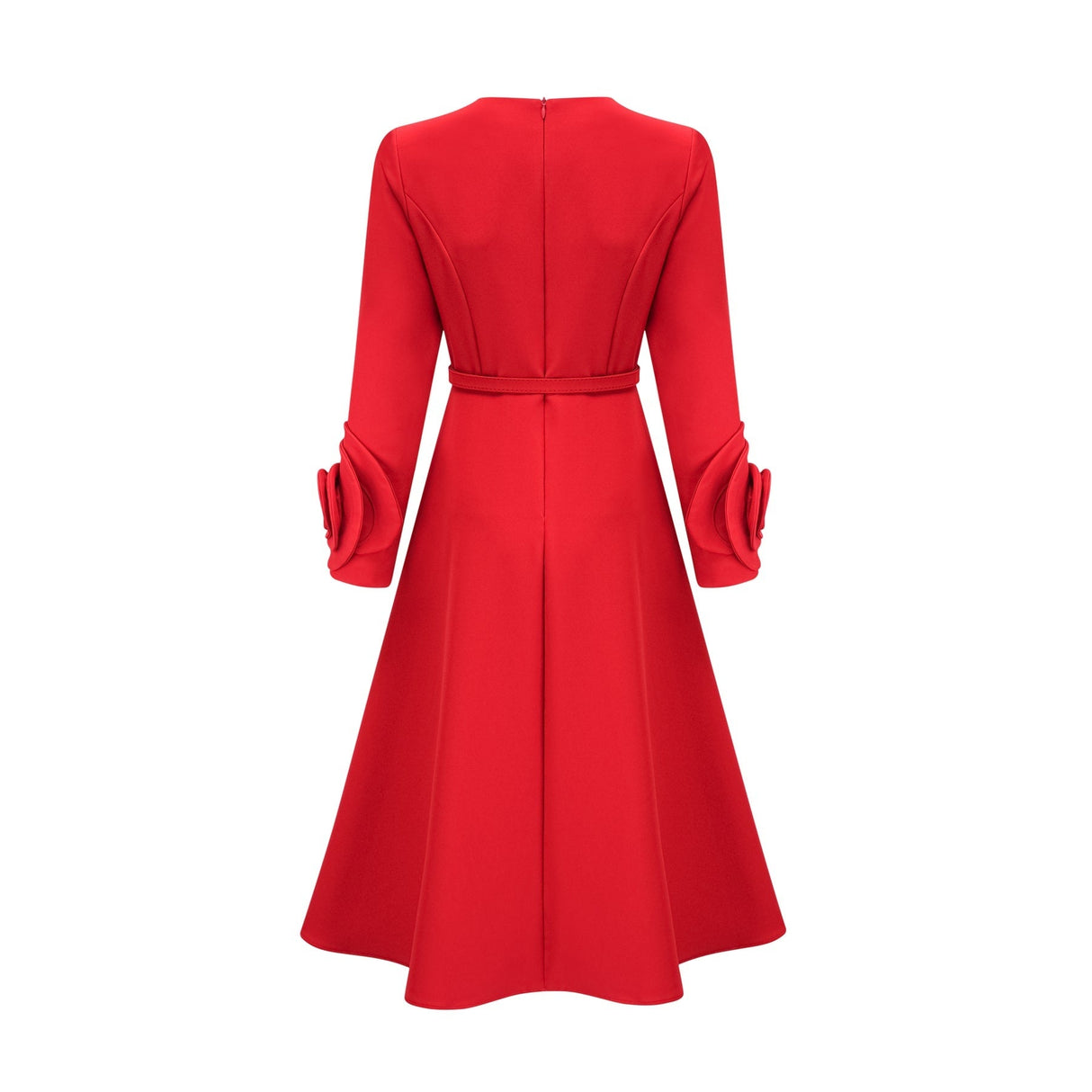 A woman wearing a red long sleeve dress with floral patterns standing in a neutral background