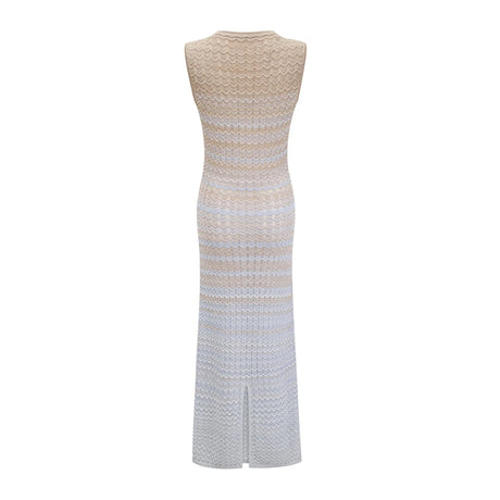 A woman wearing a ribbed knit midi dress with contrasting colors named Pauline The dress features a fitted silhouette and falls to mid calf length