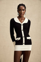 A woman wearing a short ribbed knit dress made of wool with contrasting color blocks in a fitted style with long sleeves