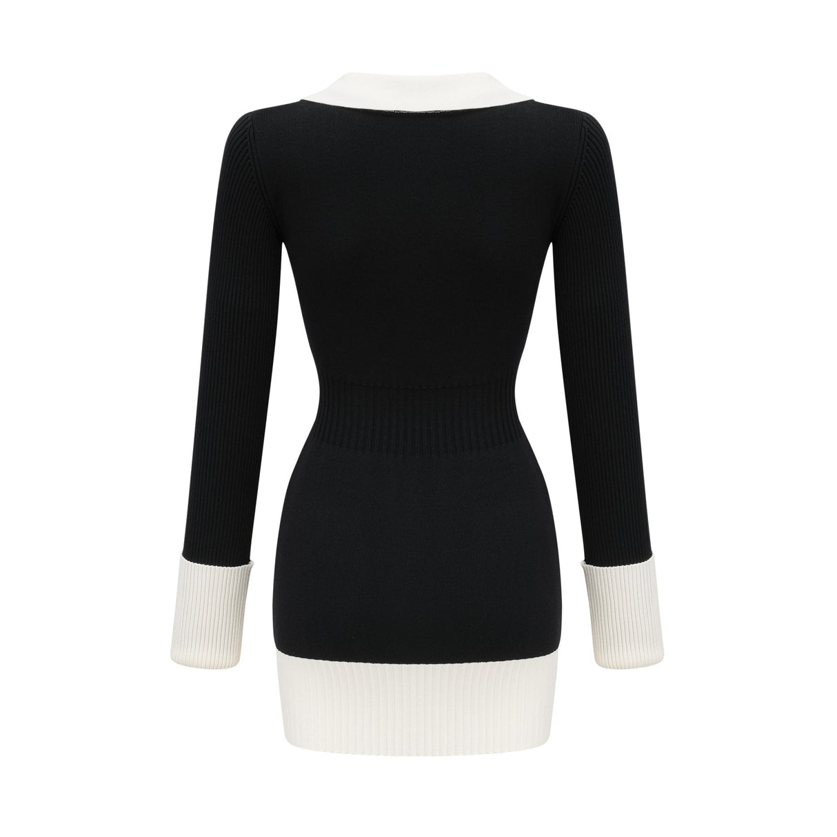 A woman wearing a short wool dress with color blocks and ribbed texture featuring long sleeves and a high neckline