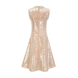 A woman wearing a sparkling midi length dress with sequins and faux pearls adorning the fabric standing in an elegant pose