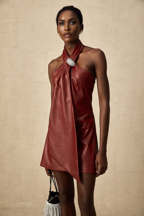 A woman wearing a vibrant red mini dress made of sheepskin with a halter neckline