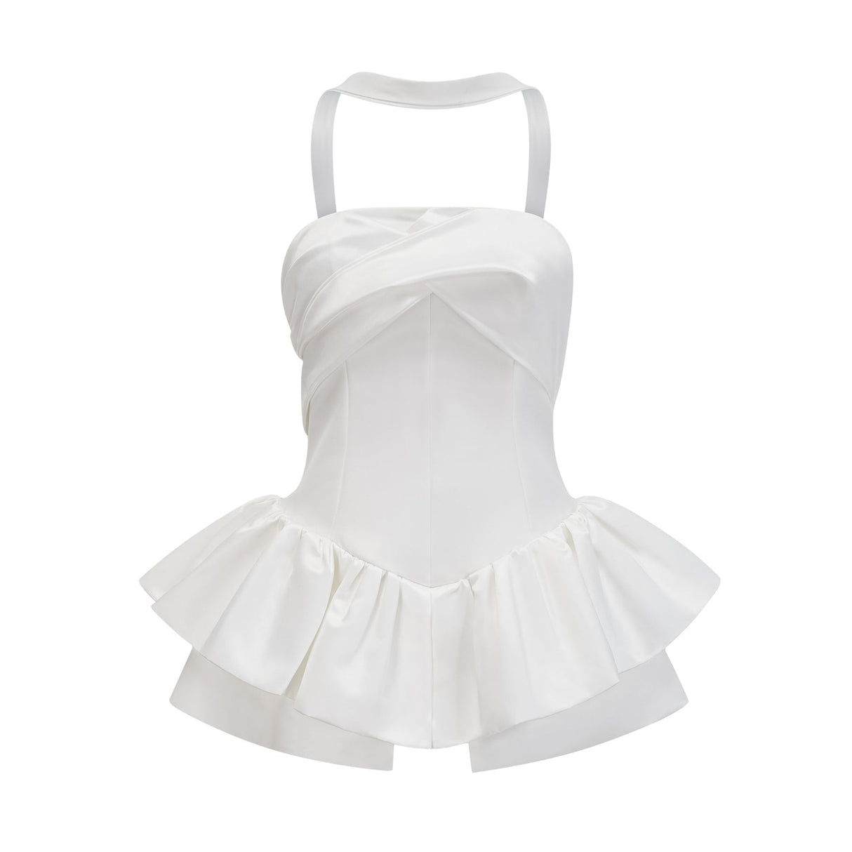 A woman wearing a white halterneck mini dress with ruffled details standing against a plain background