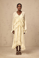 A yellow midi dress with a floral print pattern made of chiffon fabric featuring ruffle details and a flowing silhouette