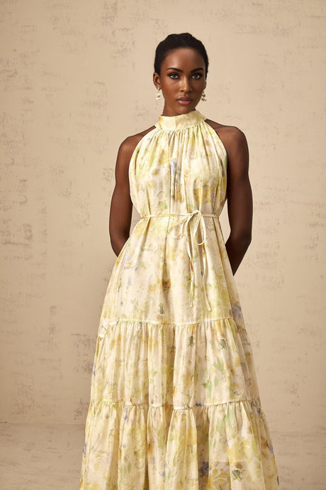 A yellow sleeveless midi dress with a floral print pattern called Ulani