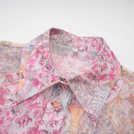 A young girl wearing a cherry pink shirt and skirt set with a pattern print design the top and bottom match creating a coordinated outfit