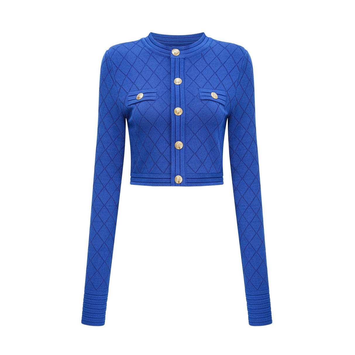 A young woman wearing a blue knitted two piece outfit consisting of a long sleeve top with button details and a matching skirt
