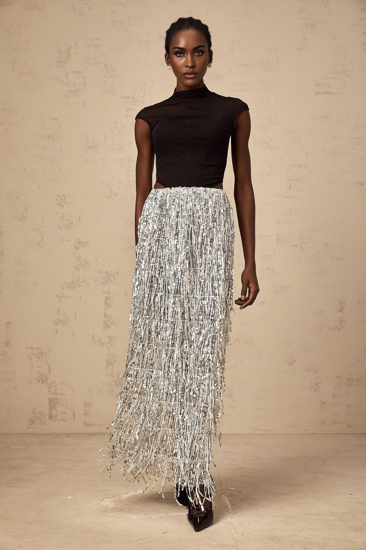 A young woman wearing a twotone corset style top and matching skirt set The top is fitted with a laced front and the skirt is form fitting The outfit has contrasting colors one light and one dark creating a striking visual effect