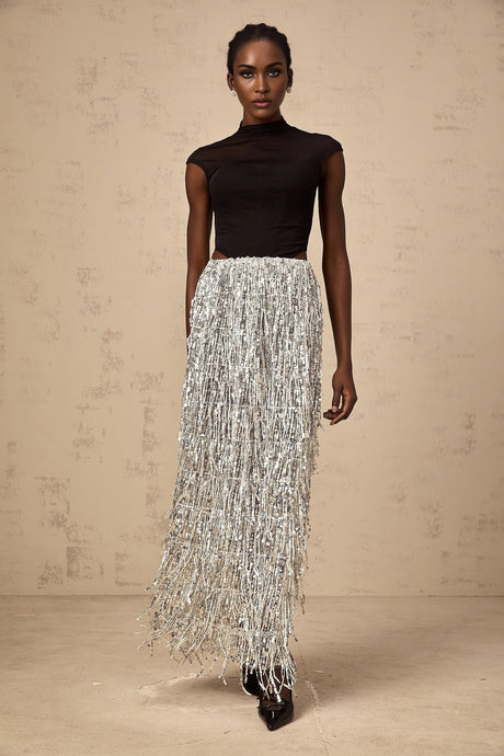 A young woman wearing a twotone corset style top and matching skirt set The top is fitted with a laced front and the skirt is form fitting The outfit has contrasting colors one light and one dark creating a striking visual effect