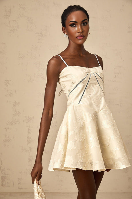 Adabella white mini dress with floral jacquard pattern on a plain background
