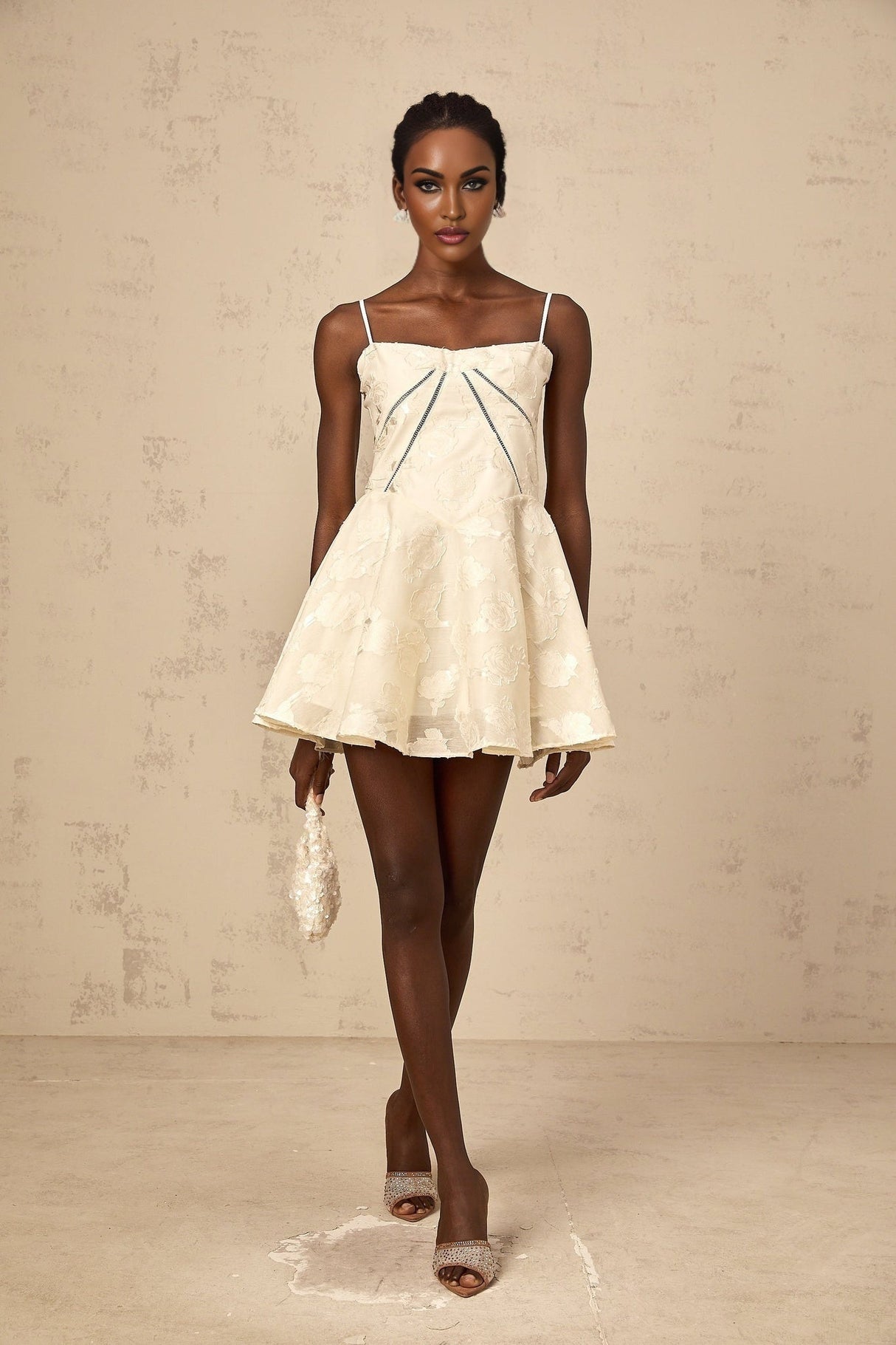 Adabella white mini dress with floral jacquard pattern on fabric model wearing dress against plain background