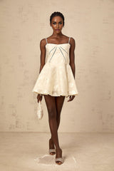 Adabella white mini dress with floral jacquard pattern on fabric model wearing dress against plain background