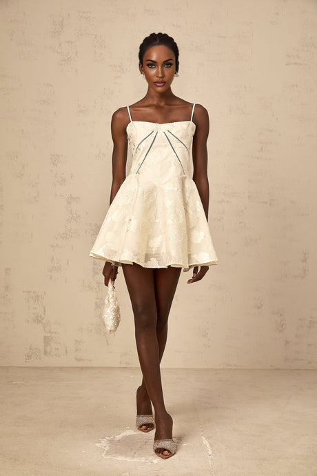 Adabella white mini dress with floral jacquard pattern on fabric model wearing dress against plain background