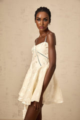 Adabella white mini dress with floral jacquard pattern on fabric shown against plain background
