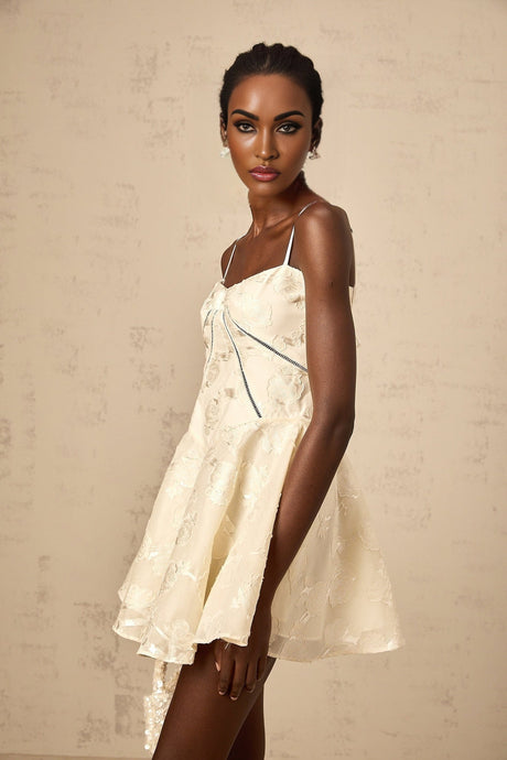 Adabella white mini dress with floral jacquard pattern on fabric shown against plain background