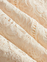 Delicate and romantic, this exquisite lace dress features a soft peach hue that adds a touch of elegance to any occasion..