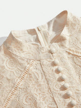 This elegant dress features a delicate lace overlay in a soft ivory hue, showcasing an intricate floral pattern that exudes.