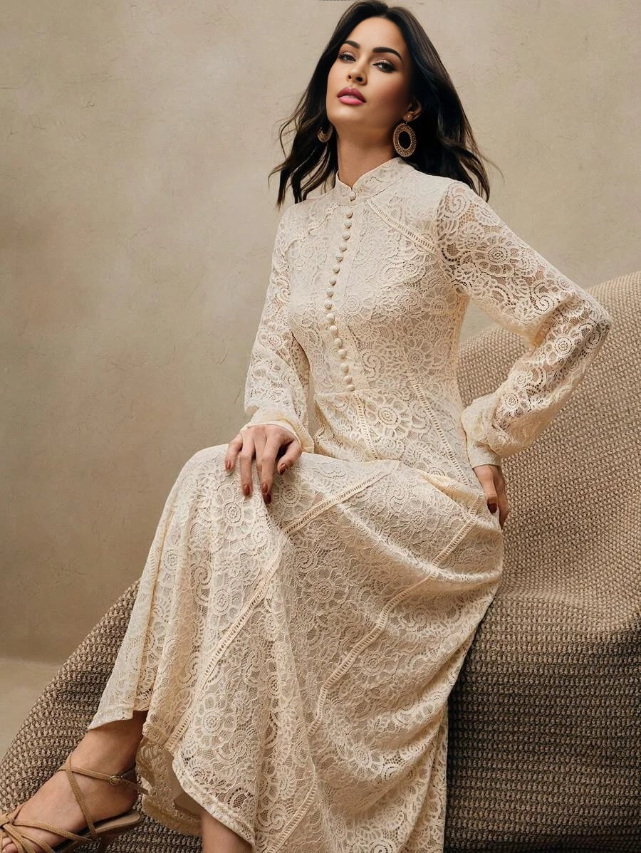 This elegant cream lace dress features a delicate floral pattern and a chic high neck with button detailing, beautifully.