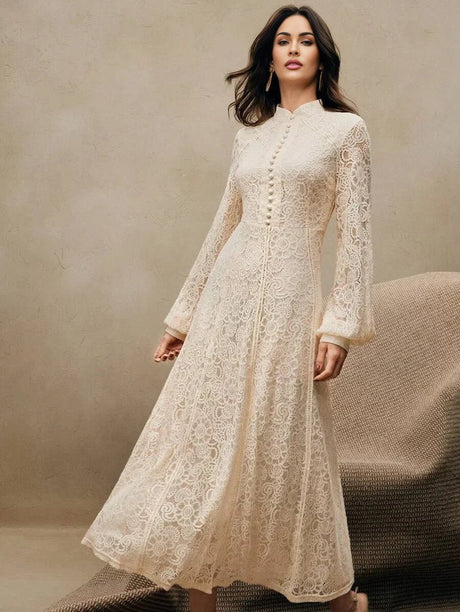This elegant ivory lace dress features a floor-length design with a chic mandarin collar and delicate button details,.
