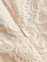 Delicate and romantic, this sleeveless dress features a soft blush color adorned with intricate lace patterns, showcasing an.