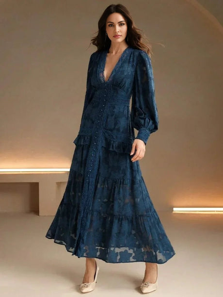This enchanting deep blue dress features a flowing maxi silhouette with elegant puff sleeves and intricate lace detailing.
