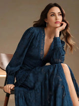 A stunning navy blue dress featuring an elegant floral lace design, with billowy sleeves and a flattering fit that.