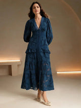 Dive into elegance with this deep navy tiered dress, featuring long puff sleeves and a flattering V-neckline. Crafted from a.