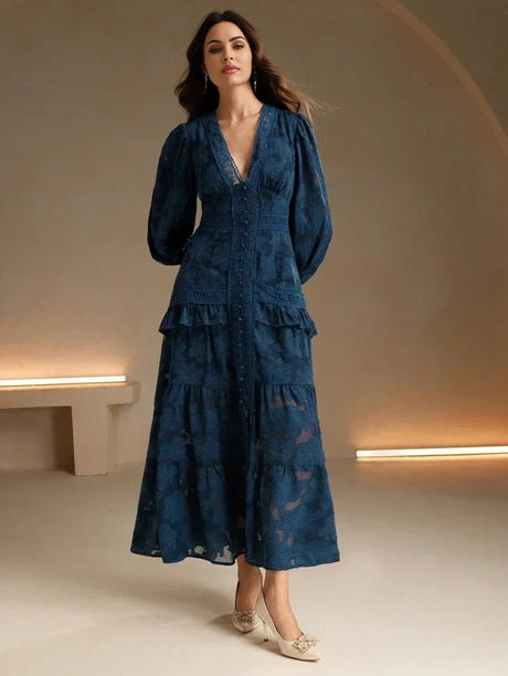 Dive into elegance with this deep navy tiered dress, featuring long puff sleeves and a flattering V-neckline. Crafted from a.
