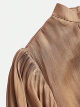 Elevate your wardrobe with this elegant taupe dress, featuring a sophisticated pleated design that drapes beautifully and.
