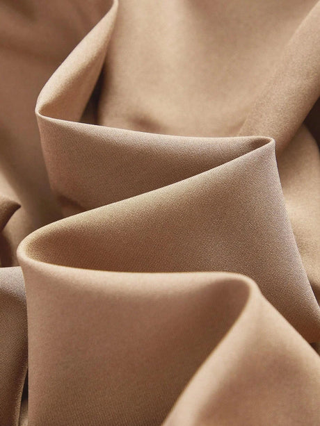 Experience the luxurious feel of this elegant dress made from soft, flowing fabric in a warm, rich taupe color. The.
