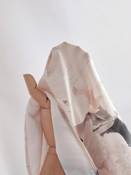 A delicate, flowing dress crafted from light, floral-printed fabric in soft pastels, featuring a relaxed fit that perfectly.