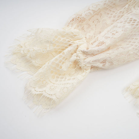 Anaelle blouse in off white color featuring a bowknot and floral lace pattern