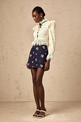 Anaelle blouse in off white color with a bow detail and floral lace pattern