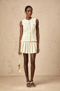 Beige knit vest top and skirt set with sequin embellishments matching outfit named Helene