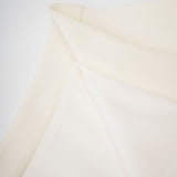 Beige matching set featuring sleeveless top and skirt with 3D floral petal details