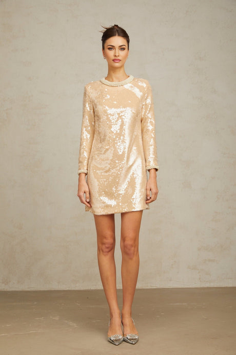 Beige mini dress with faux pearl and sequin embellishments on a mannequin
