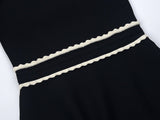 Black A-line silhouette dress with lace collar and puffed sleeves
